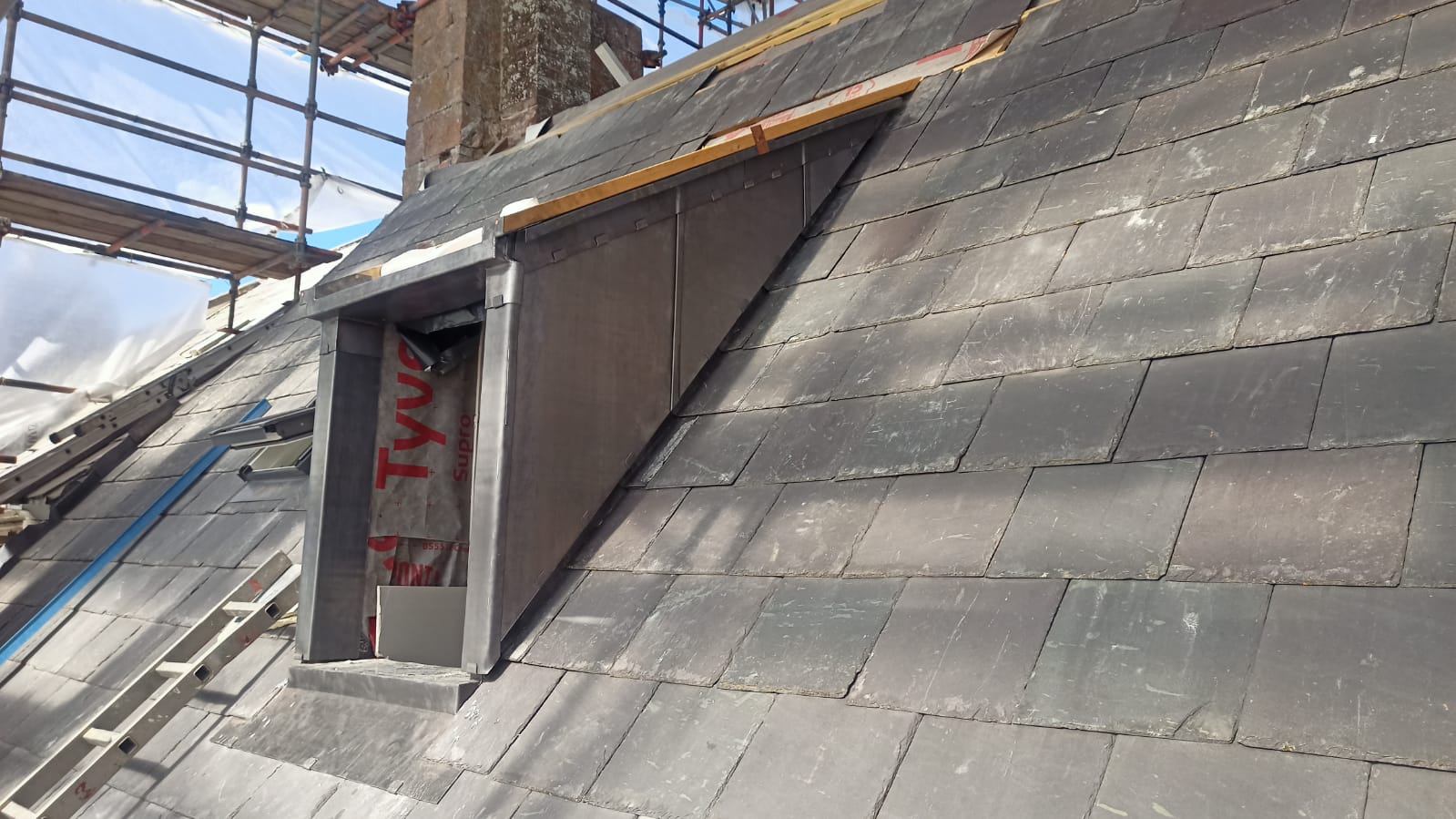 Lead-clad dormer cheeks meeting natural slate roof, Le Hocq