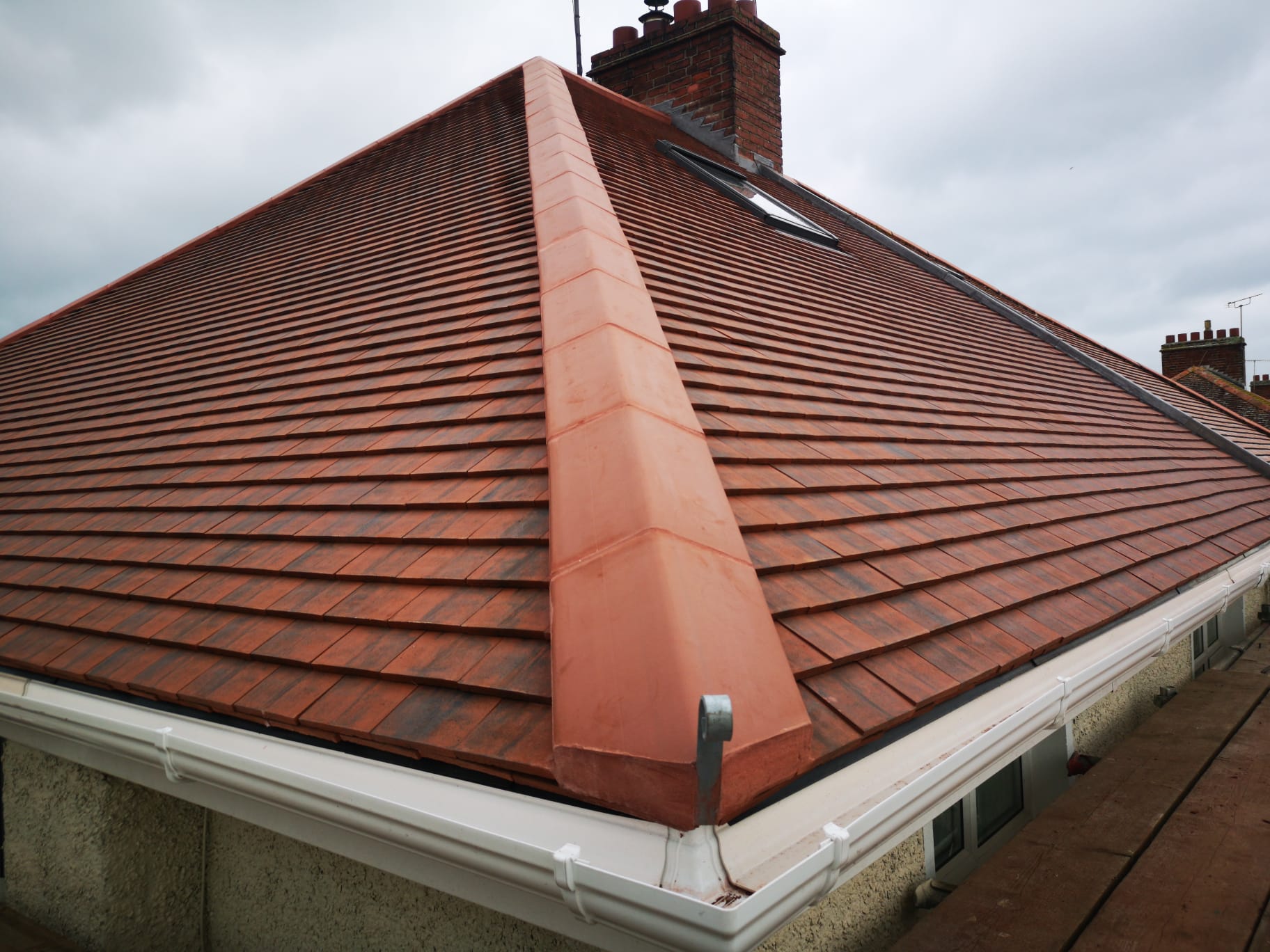 Red plain tile hipped roof with clay hip tiles
