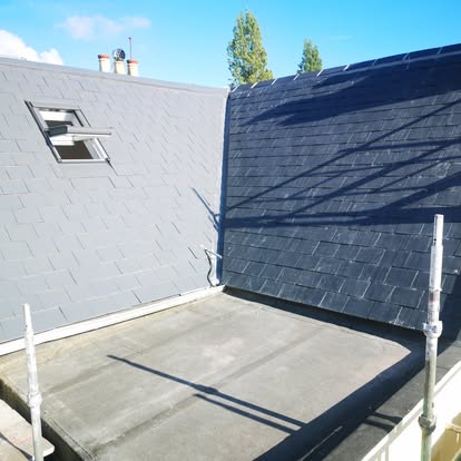 Fresh slate pitched roof meeting a flat roof terrace