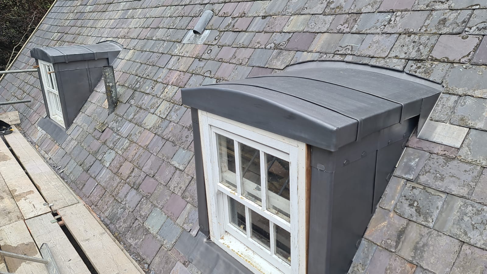 Two lead-clad dormers with curved tops on a slate roof, Franc Fief