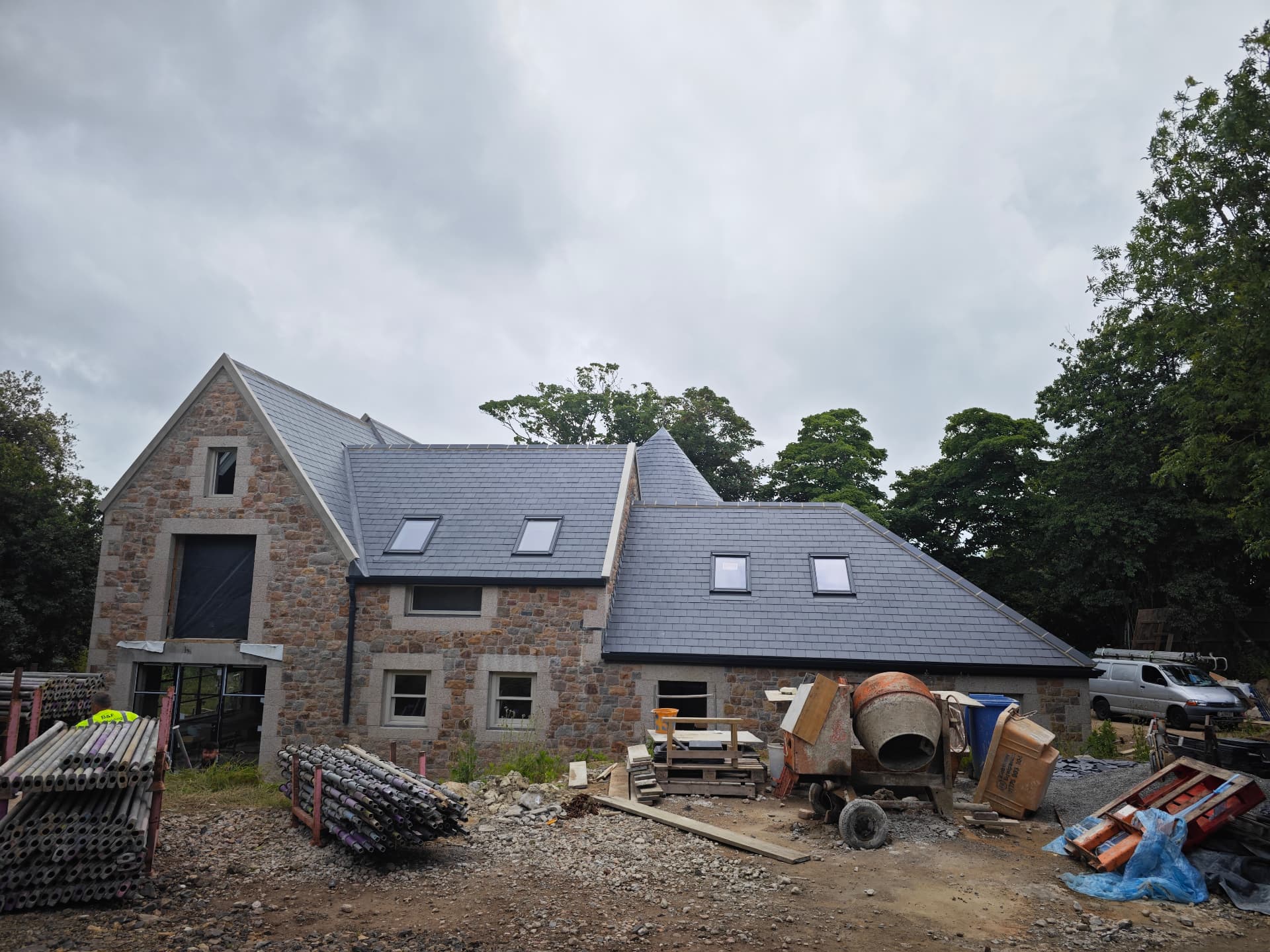 Spanish slate roof slopes across a granite barn conversion, La Grande Rue