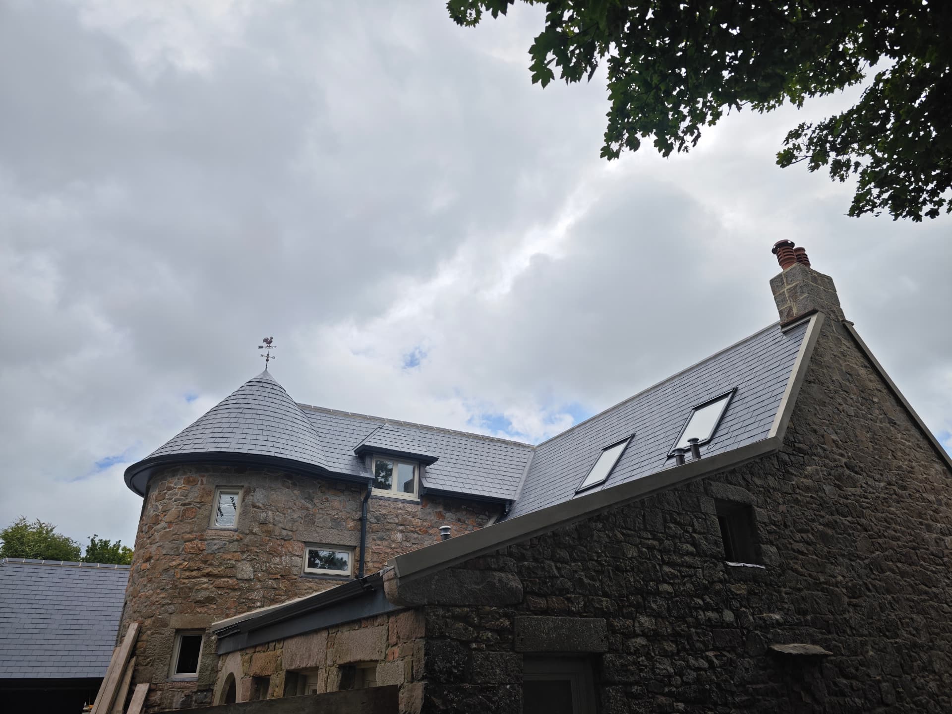 Slate turret with weathervane beside a slated gable, La Grande Rue