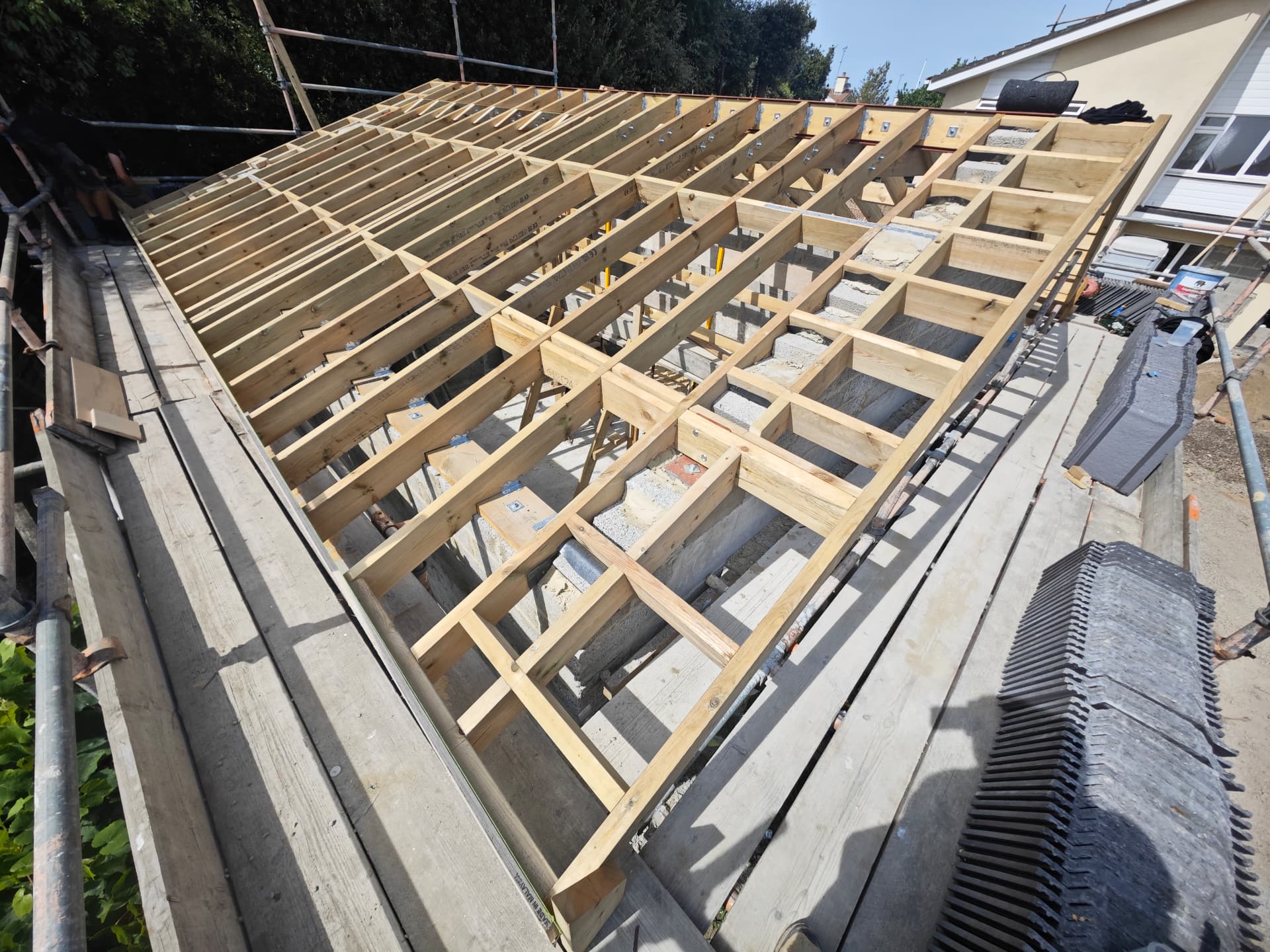 New timber roof structure with rafters ready for tiling, Kampong