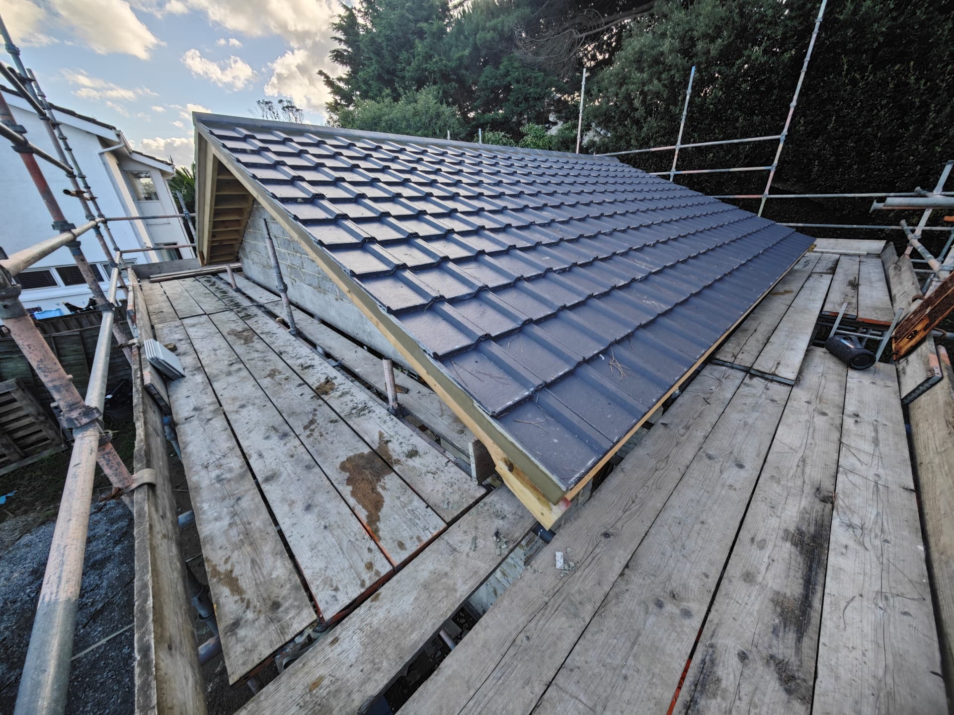 Newly tiled new build roof slope with lead verge, Kampong