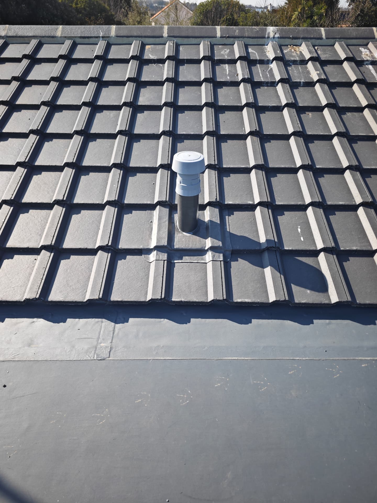Tile vent detail with lead soaker on a new build roof, Kampong
