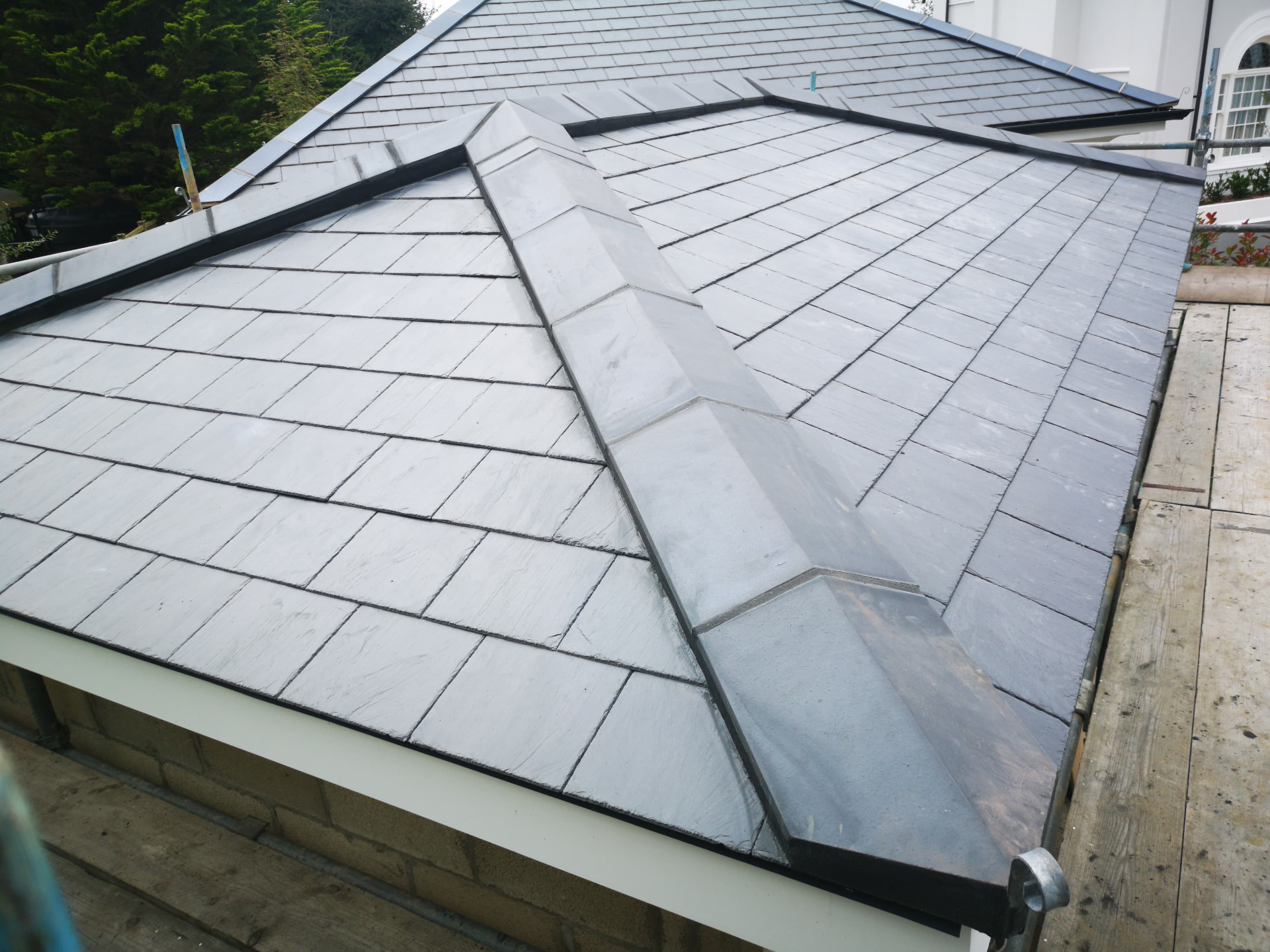 New natural slate roof with lead hip rolls on a pool house