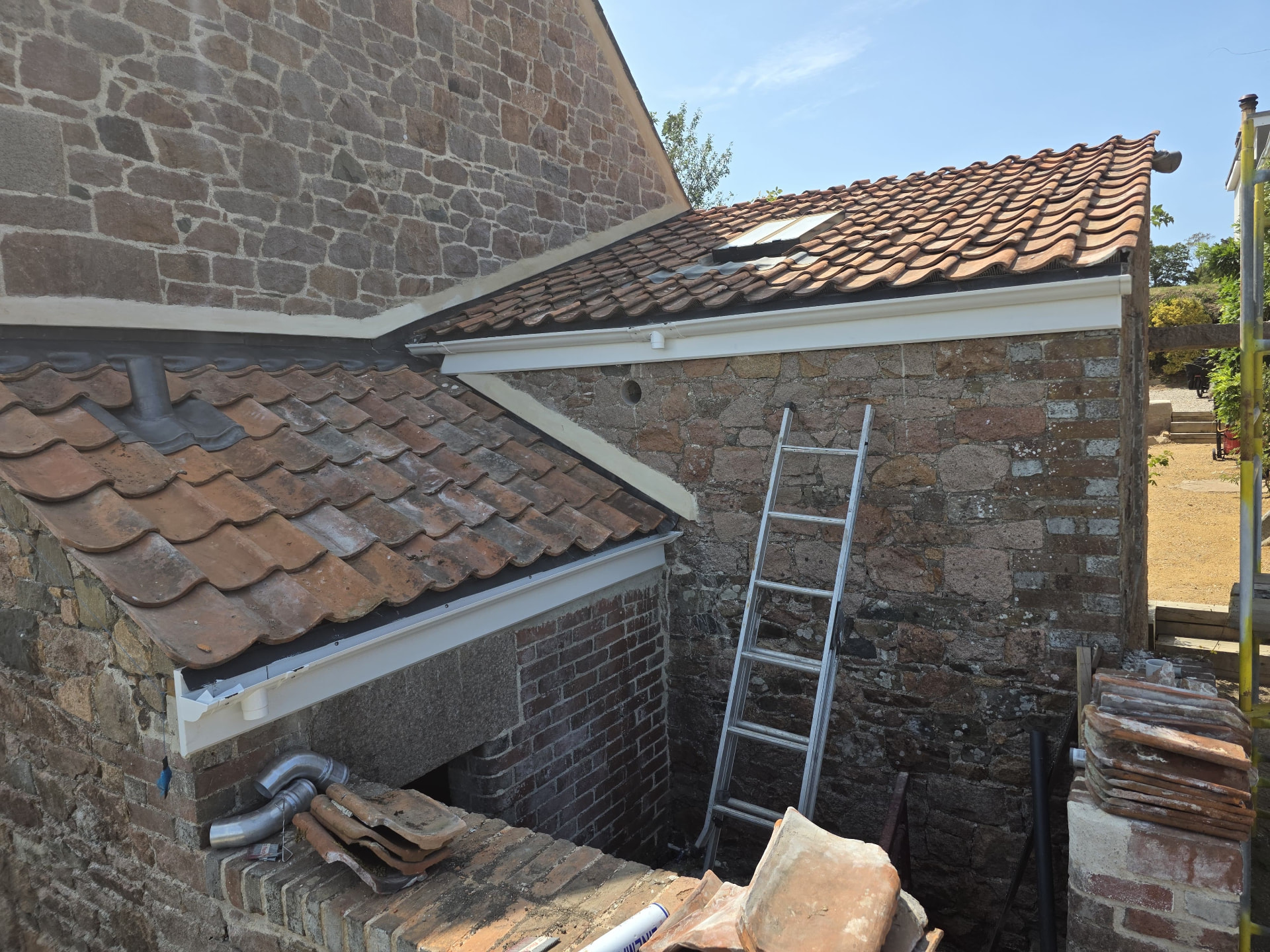 Reroofed clay pantile slopes on a granite outbuilding, Douceville