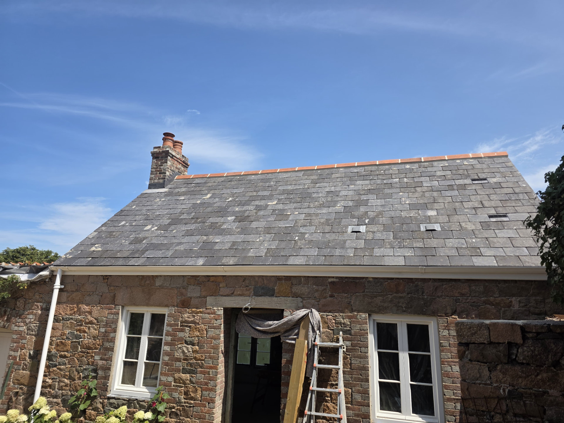 Reclaimed slate roof with clay ridge on a granite cottage, Douceville