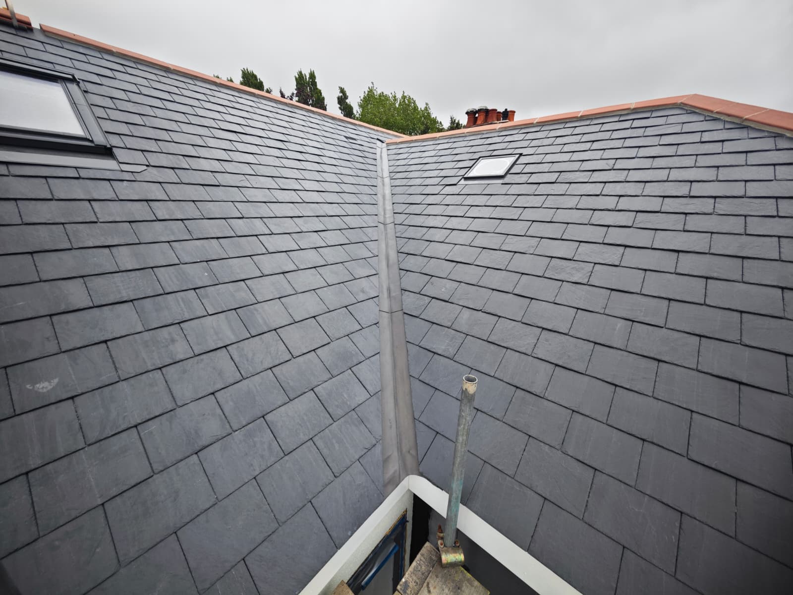 Two new slate roof slopes meeting at a lead valley with rooflights, L'Enclos Cottages