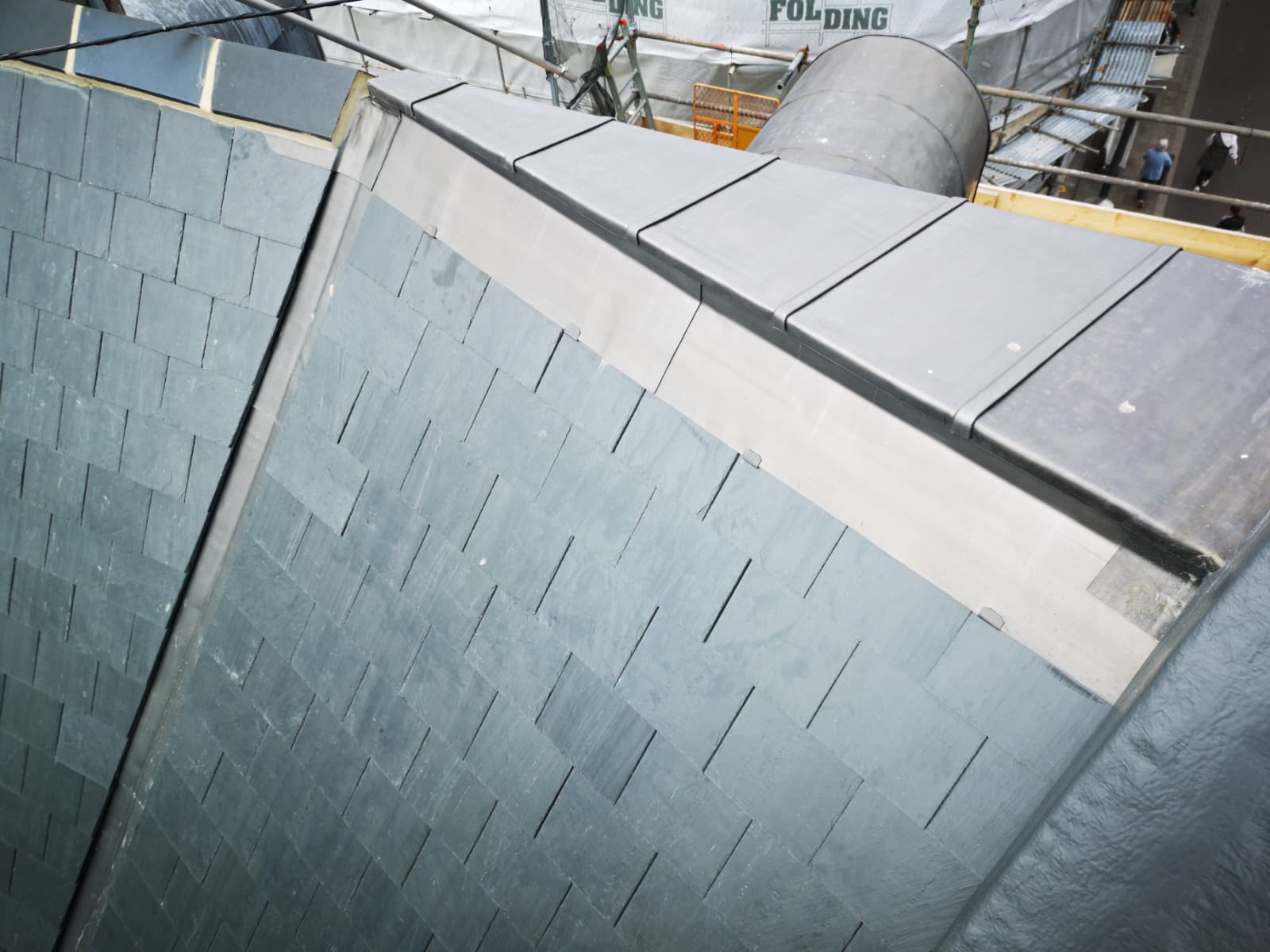 Lead ridge and slate slopes on a town centre roof, Broad Street