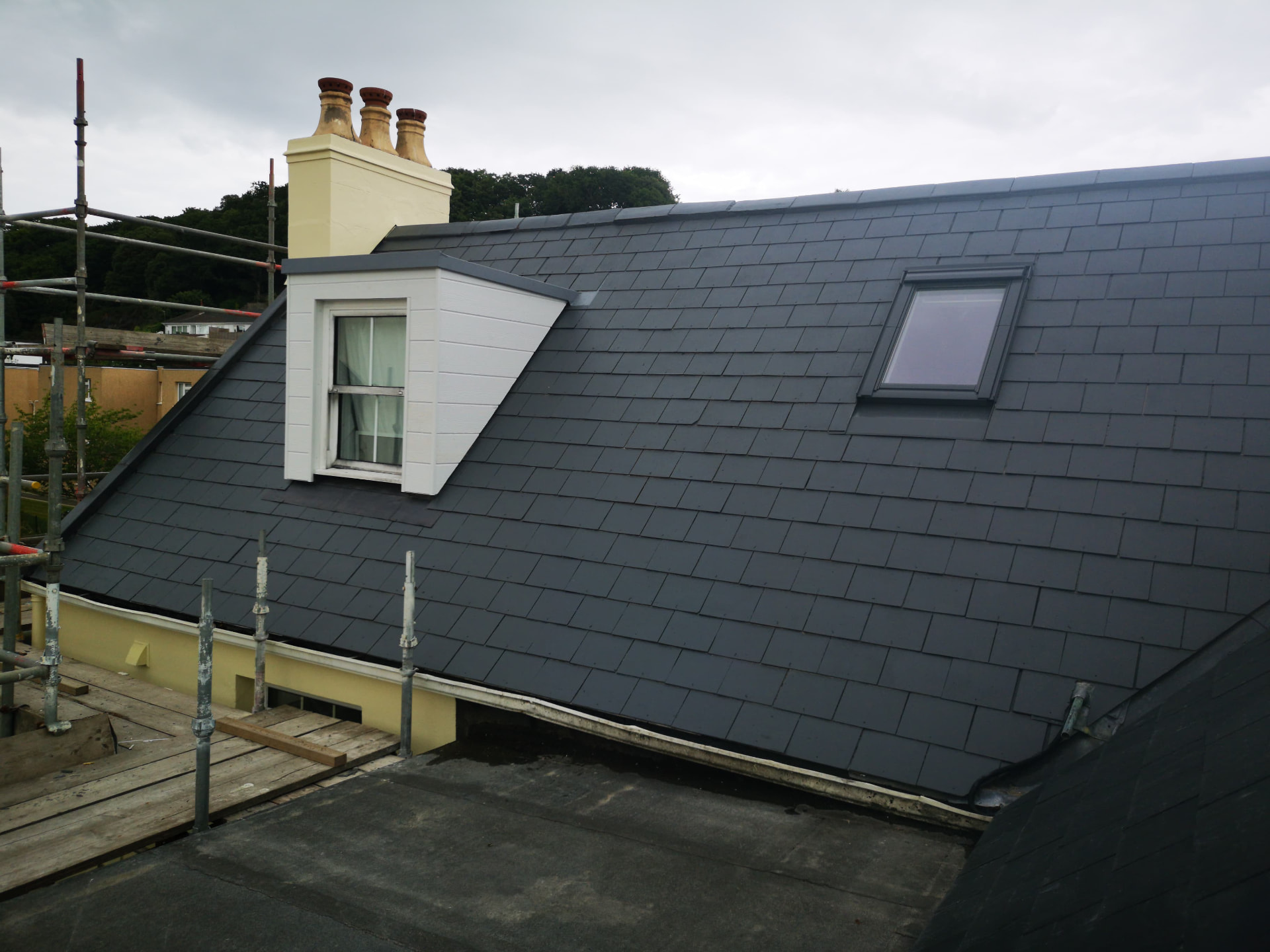 Reroofed slate slope with white timber dormer and Velux window, Brookvale