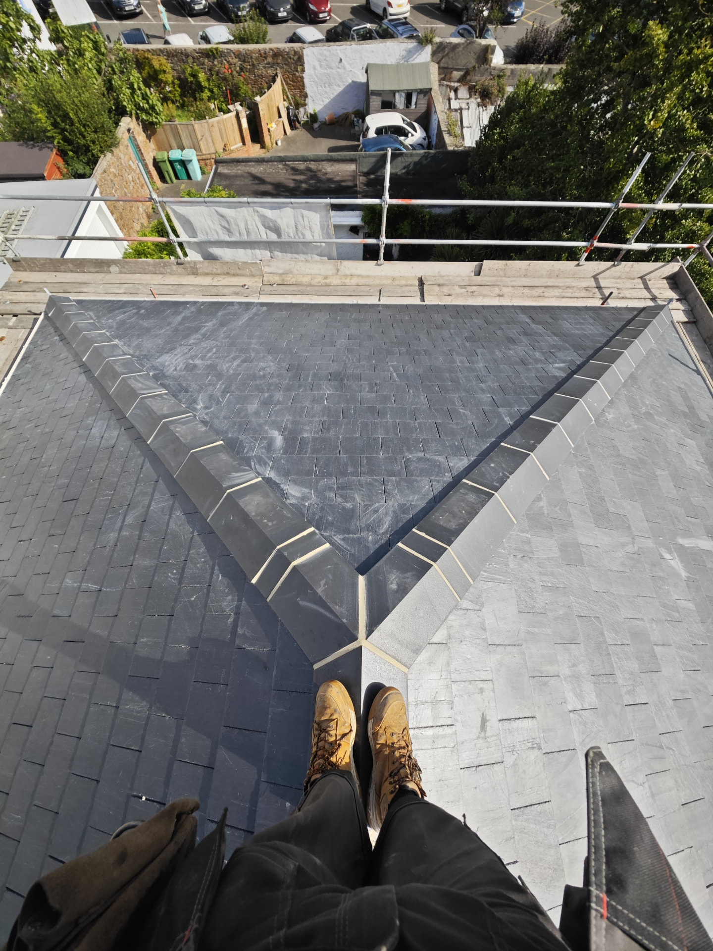 Aerial view of a new slate hipped roof with lead hip rolls, L'Abri