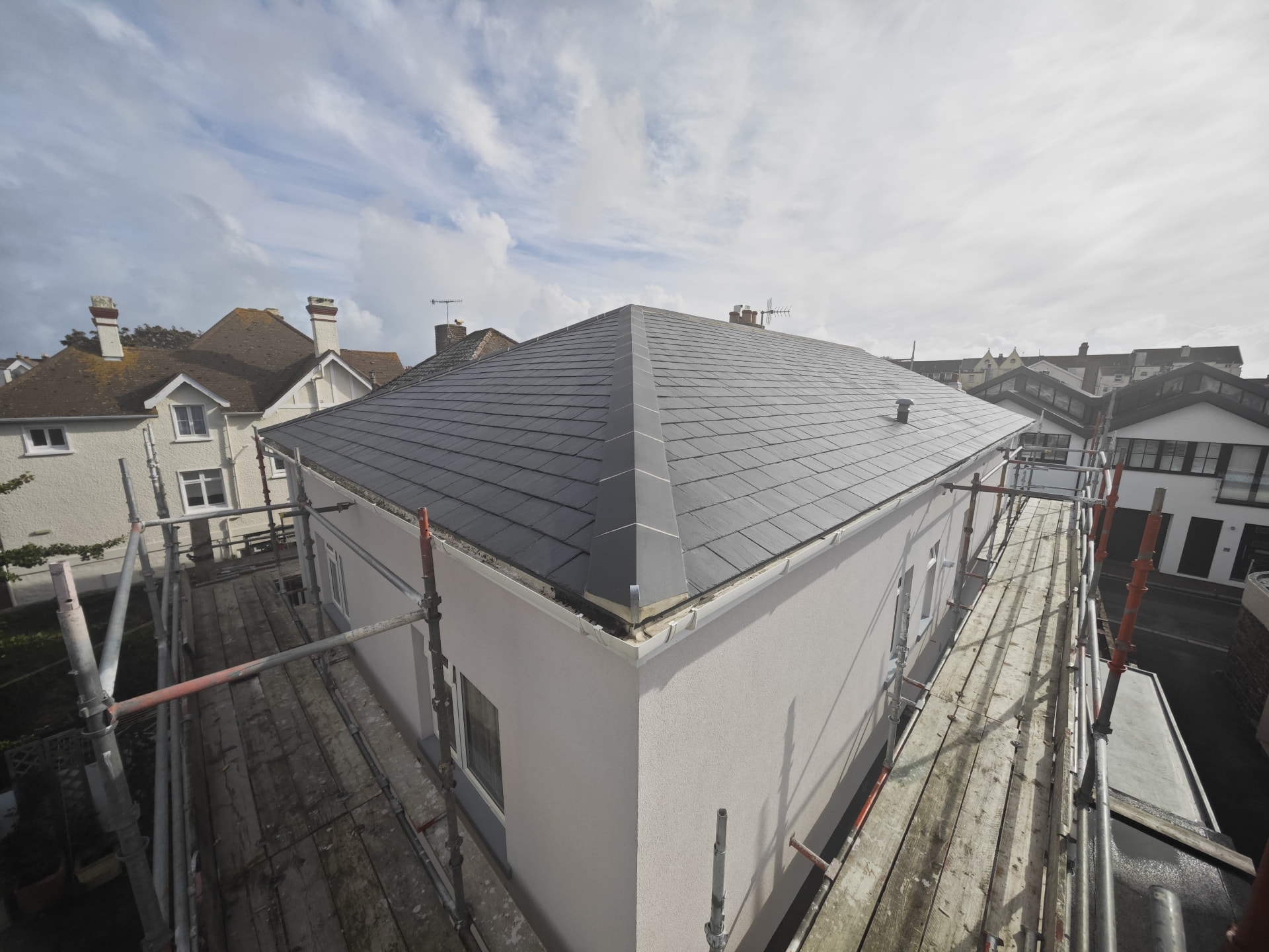 Hipped slate roof with lead hips on a rendered house, L'Abri