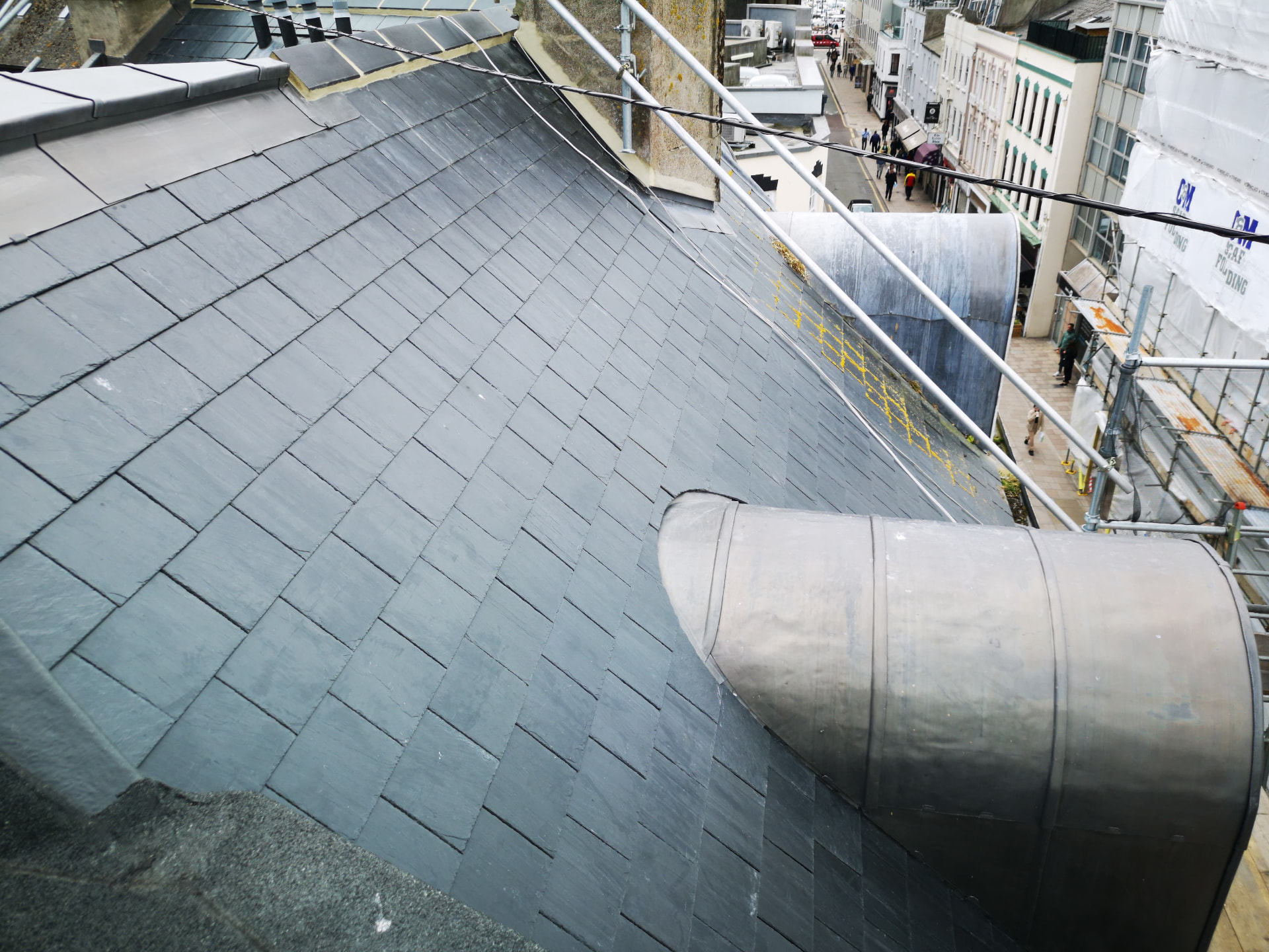 Slate roof with curved lead barrel dormers above a town street, Broad Street