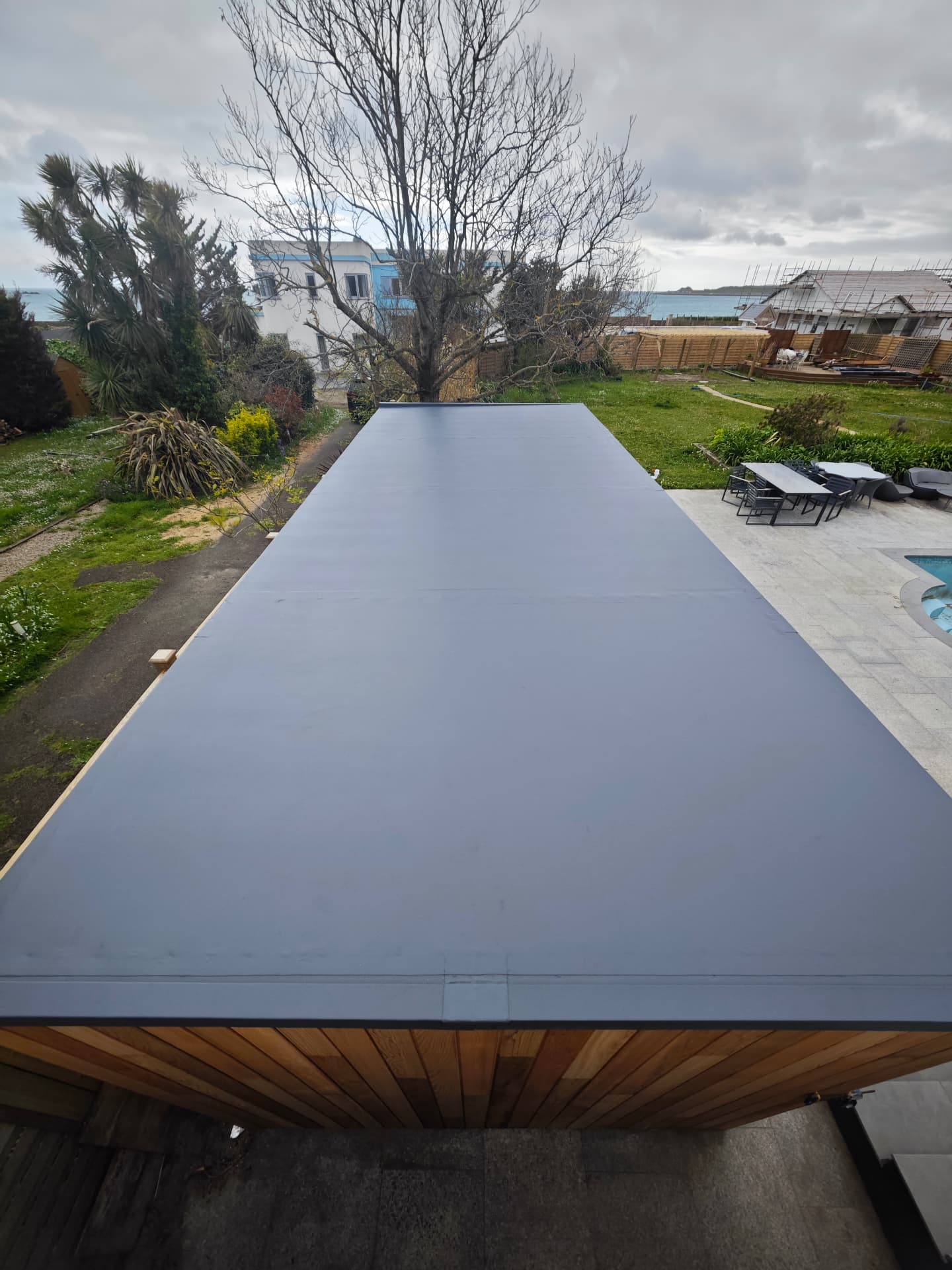 SikaPlan single-ply membrane flat roof on a cedar-clad garden room, La Cote