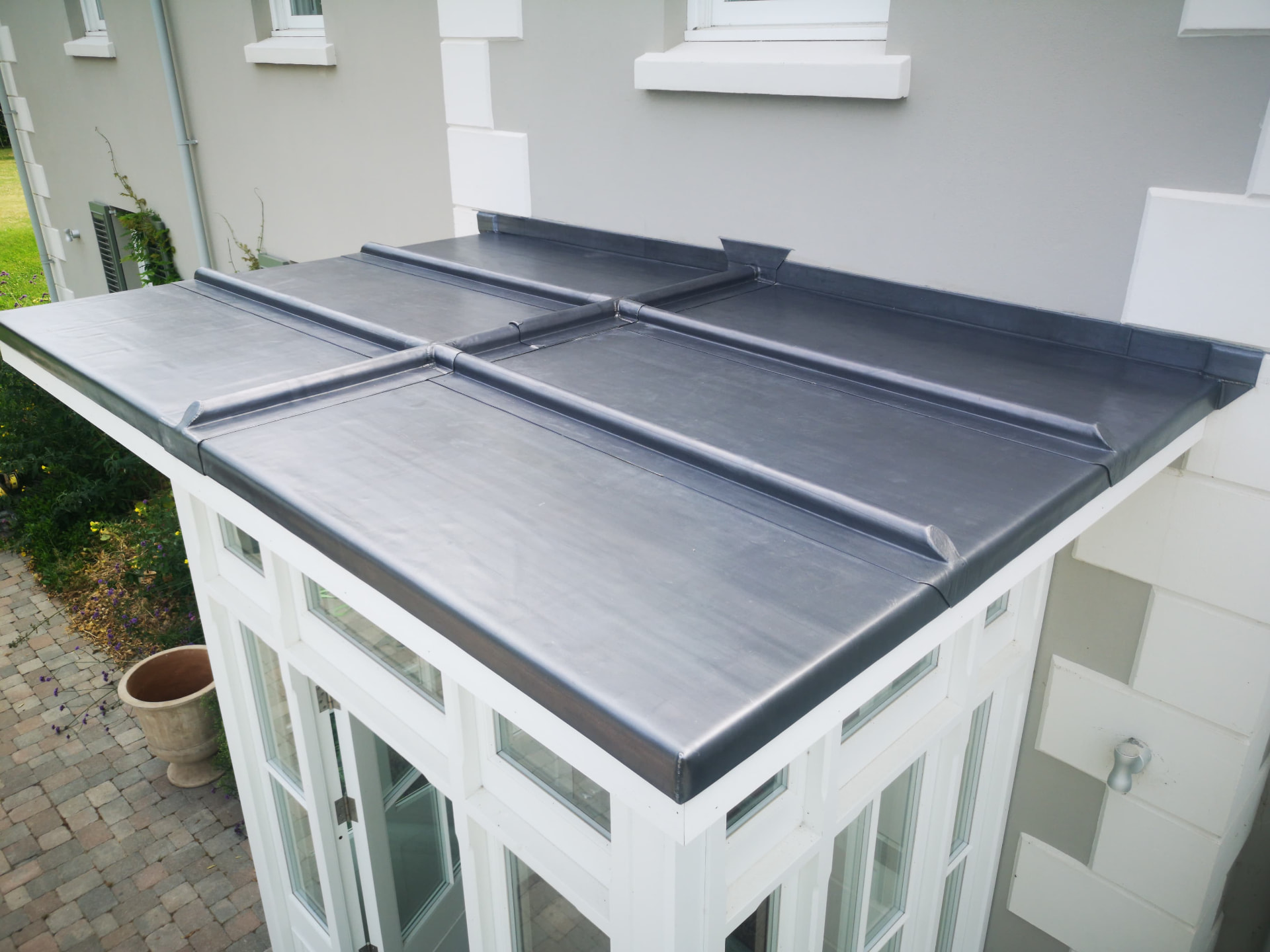 Lead roll top porch roof with welted rolls over a glazed porch, Crows Nest