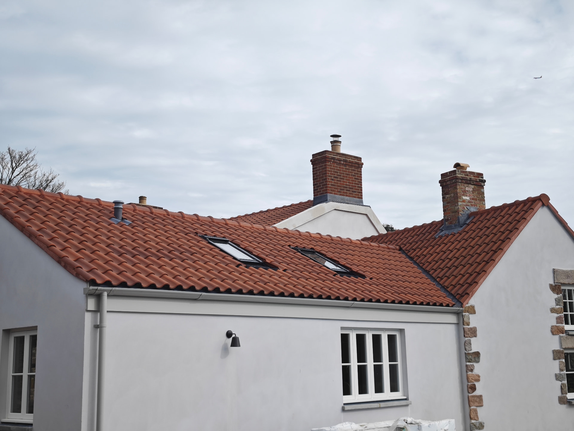 Clay pantile roof with brick chimneys, lead flashings and Velux windows, Rose Cottage
