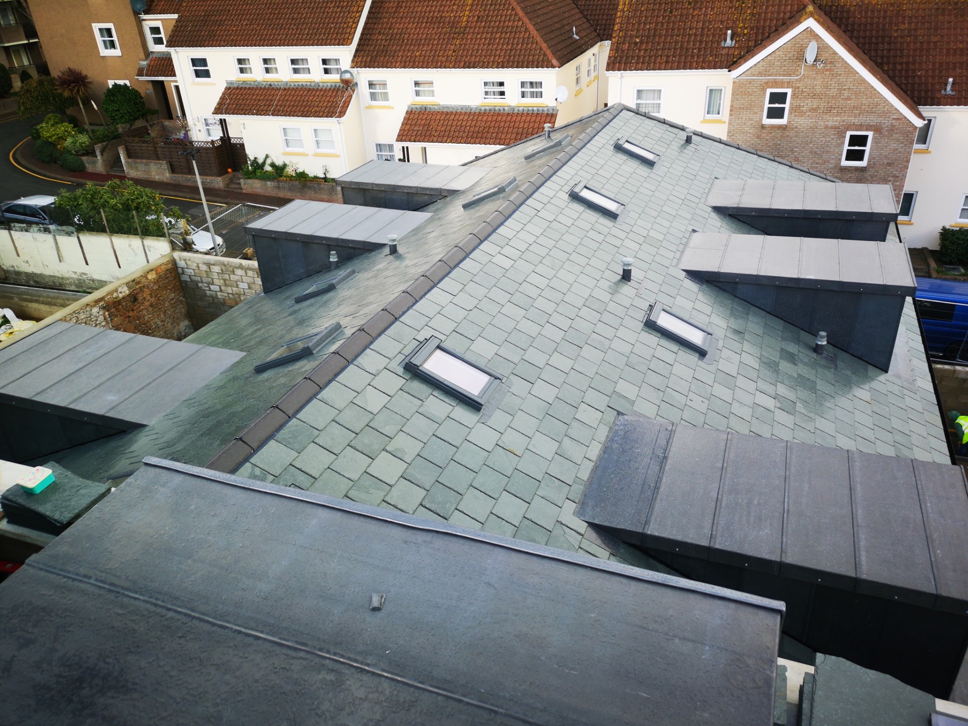 Aerial view of a complex slate roof with dormers and leadwork